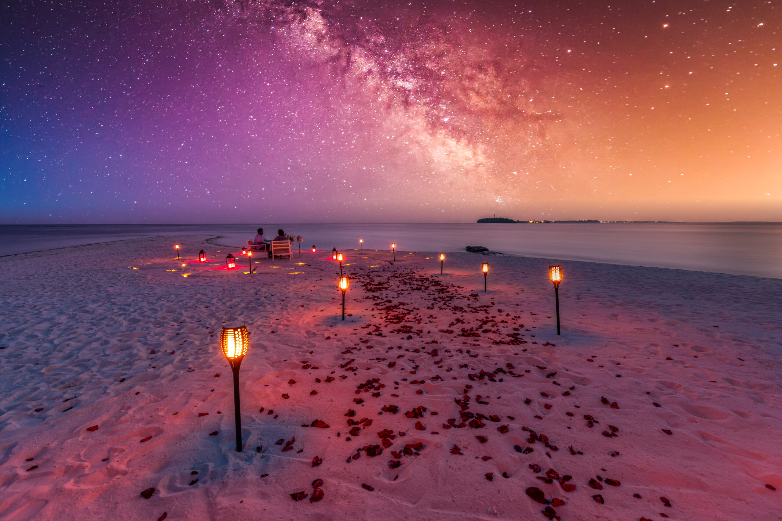 Amazing beach dinner setting under Milky Ways night sky in maldives. Book with Halo Flights USA.