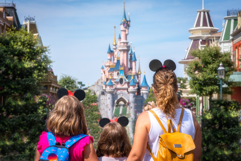 a family looking at disneyland paris. Now it's easy to book disneyland paris vacation with Halo Flights US.