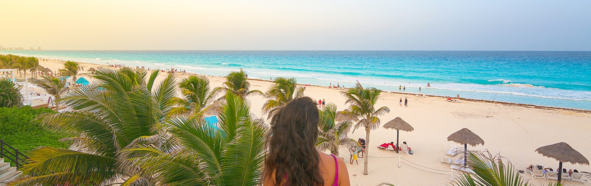 Young woman watching the beautiful Cancun beach at sunset, Mexic